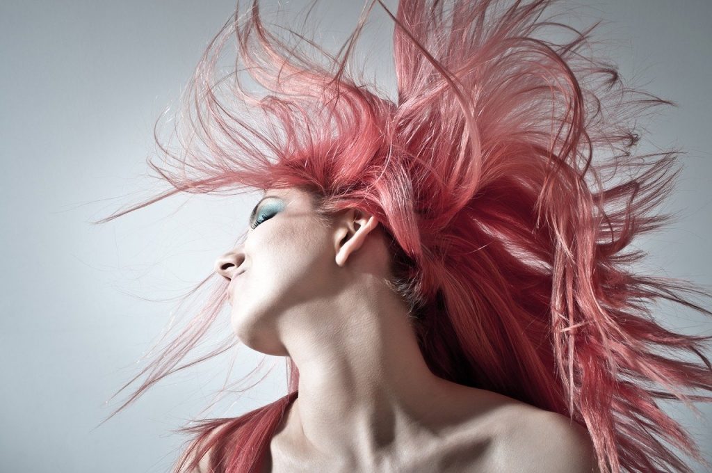 pink hair lady blowing hair